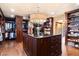 Spacious walk-in closet with a central island, custom cabinets, and ample storage for clothes and accessories at 8306 N Merion Way, Paradise Valley, AZ 85253