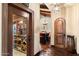 Hallway view into well-stocked wine cellar with custom wooden racks for extensive bottle storage at 8306 N Merion Way, Paradise Valley, AZ 85253