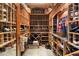 Well-organized wine cellar with custom wooden racks for extensive wine bottle and case storage at 8306 N Merion Way, Paradise Valley, AZ 85253