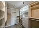 Spacious walk-in closet featuring custom shelving and ample storage space at 8525 E Keim Dr, Scottsdale, AZ 85250