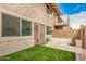 Cozy backyard with artificial turf, block wall, and hardscaped patio, perfect for outdoor living at 8532 E Belleview St, Scottsdale, AZ 85257