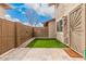 Private backyard features artificial grass, brick wall, and paved patio for a welcoming outdoor area at 8532 E Belleview St, Scottsdale, AZ 85257