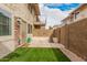 Private backyard featuring artificial grass, paved patio, and block wall for an intimate outdoor space at 8532 E Belleview St, Scottsdale, AZ 85257