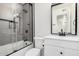 Updated bathroom with a shower/tub combo and modern vanity with a sleek mirror at 8532 E Belleview St, Scottsdale, AZ 85257