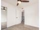 Bright bedroom with wood-look flooring, large closet, and open door to the hallway at 8532 E Belleview St, Scottsdale, AZ 85257