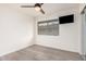 Bright bedroom with modern ceiling fan, wood-look flooring, and large horizontal window at 8532 E Belleview St, Scottsdale, AZ 85257