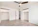 Spacious bedroom with walk-in closets, ceiling fan, and neutral flooring at 8532 E Belleview St, Scottsdale, AZ 85257