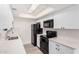 Modern kitchen with white cabinets, stainless steel appliances, and ample counter space at 8532 E Belleview St, Scottsdale, AZ 85257