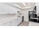 Modern kitchen with white cabinets, stainless steel appliances, and quartz countertops at 8532 E Belleview St, Scottsdale, AZ 85257