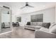 Bright living room with a ceiling fan, a sectional sofa, and luxury vinyl plank flooring at 8532 E Belleview St, Scottsdale, AZ 85257