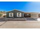 Charming home featuring desert landscaping, a sunny sky, and a convenient carport for easy parking at 869 E Tee St, San Tan Valley, AZ 85140