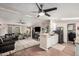 Bright living room and kitchen featuring stainless steel appliances, wood floors, ceiling fans, and lots of natural light at 869 E Tee St, San Tan Valley, AZ 85140