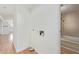 Hallway with laundry hookups leading to a bathroom with tub and shower at 8823 E Billings St, Mesa, AZ 85207