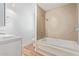 Updated bathroom with tub and shower featuring tiled walls at 8823 E Billings St, Mesa, AZ 85207