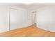 This is a bedroom with wood floors, a closet, a window and base molding at 8823 E Billings St, Mesa, AZ 85207