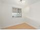 Bright, empty bedroom with wood floors, neutral walls, and natural light at 8823 E Billings St, Mesa, AZ 85207
