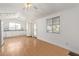 Open kitchen featuring white appliances, white cabinets, and hardwood floors at 8823 E Billings St, Mesa, AZ 85207