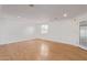 Living room featuring hardwood floors, white walls, natural lighting, and baseboards at 8823 E Billings St, Mesa, AZ 85207