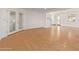 Spacious living room featuring hardwood floors, white walls, and double doors at 8823 E Billings St, Mesa, AZ 85207