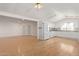 Open living space featuring hardwood floors, white walls, and access to the kitchen at 8823 E Billings St, Mesa, AZ 85207