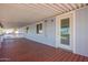 Covered porch featuring dark wood flooring, white railings, and natural lighting at 8823 E Billings St, Mesa, AZ 85207