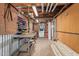 Large unfinished storage room with built in work tables and wood flooring at 8823 E Billings St, Mesa, AZ 85207
