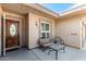 Comfortable covered patio with seating area, perfect for relaxing outdoors with outdoor chairs and glass table at 9429 W Raintree Dr, Sun City, AZ 85351