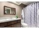 Bathroom features a single sink vanity, decorative mirror, and a shower-tub combination at 9543 E Palomino Pl, Sun Lakes, AZ 85248