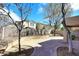 Beautiful backyard featuring a paved patio and thoughtfully landscaped areas with mature trees at 1293 E Clifton Ave, Gilbert, AZ 85295