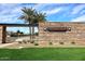 The Spectrum at Val Vista stone entrance sign surrounded by lush landscaping and tall palm trees at 1293 E Clifton Ave, Gilbert, AZ 85295
