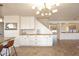 Dining area with white cabinetry, wood counters, stylish light fixture, and tile flooring at 1293 E Clifton Ave, Gilbert, AZ 85295