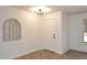 Inviting entryway with stylish light fixture, tile floors, and neutral walls at 1293 E Clifton Ave, Gilbert, AZ 85295