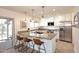 Bright kitchen with stainless steel appliances, granite counters and island with bar stool seating at 1293 E Clifton Ave, Gilbert, AZ 85295