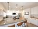Modern kitchen with stainless steel appliances, large granite island, and stylish pendant lighting at 1293 E Clifton Ave, Gilbert, AZ 85295