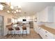Modern kitchen with stainless steel appliances, large granite island, and stylish pendant lighting at 1293 E Clifton Ave, Gilbert, AZ 85295