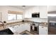 Well-lit kitchen with stainless steel appliances, granite countertops, and ample cabinet space at 1293 E Clifton Ave, Gilbert, AZ 85295
