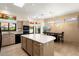 Bright kitchen featuring a center island, stainless steel appliances, and adjacent dining area at 13402 W Crown Ridge Dr, Sun City West, AZ 85375