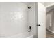 Bright bathroom showcasing a shower-tub combo with modern white and black tiling at 15050 N Thompson Peak Pkwy # 2036, Scottsdale, AZ 85260