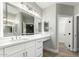 Bright bathroom featuring white cabinetry, quartz countertop and walk-in closet access at 15050 N Thompson Peak Pkwy # 2036, Scottsdale, AZ 85260