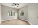Inviting bedroom with modern flooring, neutral paint, fan, and a pair of windows at 15050 N Thompson Peak Pkwy # 2036, Scottsdale, AZ 85260