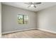 Cozy bedroom with modern flooring, ceiling fan, and a view to exterior foliage at 15050 N Thompson Peak Pkwy # 2036, Scottsdale, AZ 85260