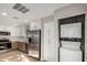 Kitchen with stainless steel appliances, including a refrigerator, stove, and stacked washer/dryer at 15050 N Thompson Peak Pkwy # 2036, Scottsdale, AZ 85260