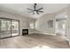 Light-filled living room with a fireplace, sliding glass doors, ceiling fan, and neutral paint at 15050 N Thompson Peak Pkwy # 2036, Scottsdale, AZ 85260