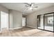 Light-filled main bedroom featuring a ceiling fan, and sliding glass doors leading to a balcony at 15050 N Thompson Peak Pkwy # 2036, Scottsdale, AZ 85260