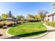 Landscaped backyard features green grass, gravel landscaping, mature trees and shrubs at 15221 N Clubgate Dr # 2012, Scottsdale, AZ 85254