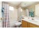 Bright bathroom features a shower-tub combo, a large mirror, and a single sink vanity at 15221 N Clubgate Dr # 2012, Scottsdale, AZ 85254