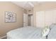This primary bedroom features neutral walls, a ceiling fan, and a comfortable bed with blue linens at 15221 N Clubgate Dr # 2012, Scottsdale, AZ 85254