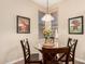 Cozy dining area with a round glass table and decorative wall art at 15221 N Clubgate Dr # 2012, Scottsdale, AZ 85254