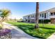 Condo community features lush green spaces with a sidewalk and mature trees at 15221 N Clubgate Dr # 2012, Scottsdale, AZ 85254