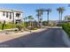 Gated entrance to a condo community with lush landscaping and mature palm trees at 15221 N Clubgate Dr # 2012, Scottsdale, AZ 85254